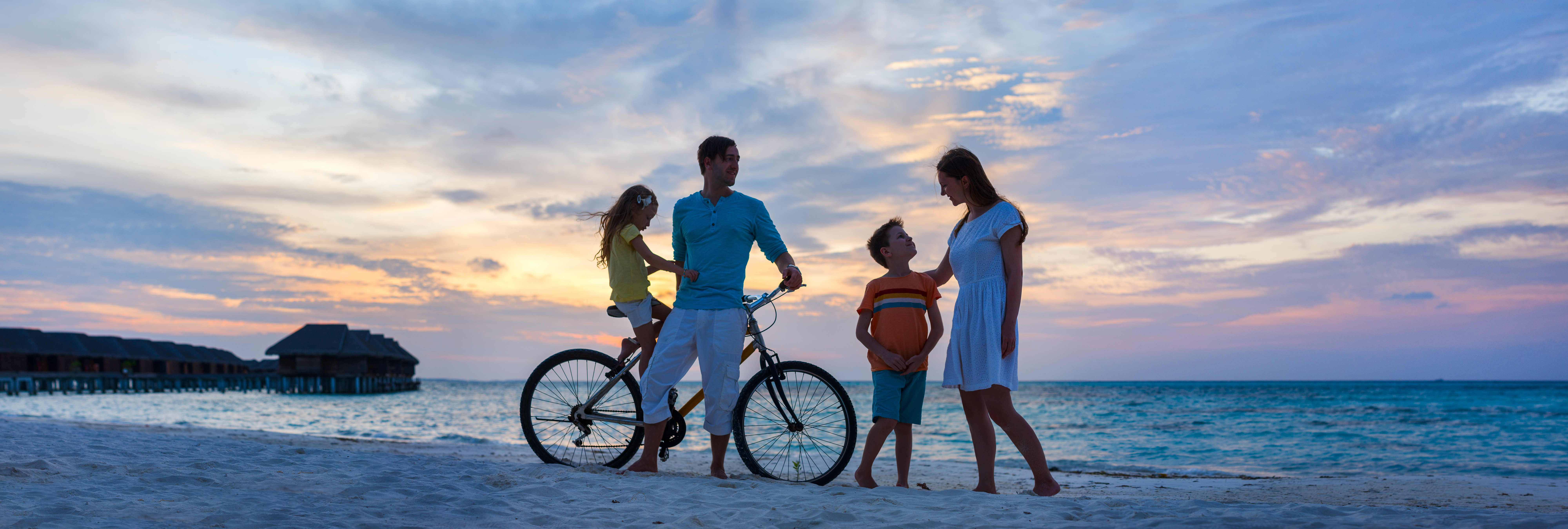 Family with a bike at beach